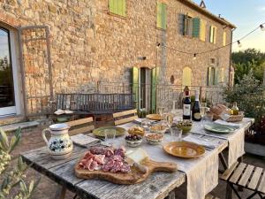 a wooden table with food on it in front of a building at La chesa de Prit in Verucchio