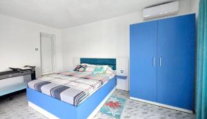 a bedroom with a blue cabinet and a bed at Guest House - Heaven in Byala +20 photos
