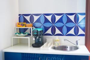 a kitchen counter with a sink and blue and white tiles at A casa di Gennarino in Cetara