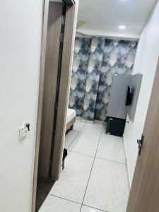a hallway with a door open to a room with a bathroom at Hotel Loya Bti in Bathinda