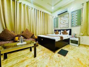 a hotel room with a bed and a couch at Hotel Keptown in Patna