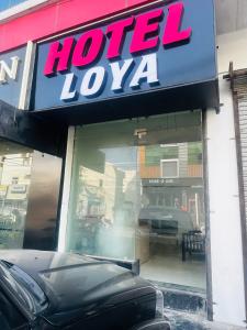 a store front with a hotel luxa sign on it at Hotel Loya Bti in Bathinda +4 photos