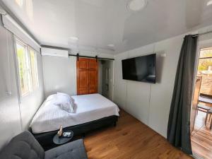a bedroom with a bed and a flat screen tv at Tierra de Gosén in Santa Cruz
