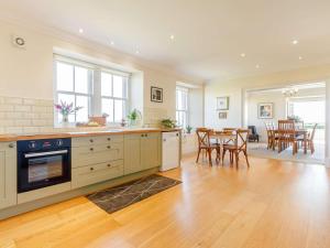 a kitchen and dining room with a table and chairs at 4 Bed in Brechin oc-89698 in Brechin