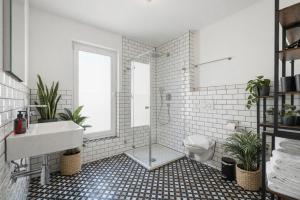 a white bathroom with a sink and a shower at Studio 04 - Einzimmerapartment klimatisiert in Friedrichshafen