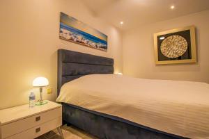 a bedroom with a large bed and a nightstand and a bed sidx sidx sidx at Casa Les Fremeaux in Altea +49 photos