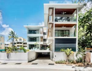an apartment building with a white facade at Ti Paradis with Private rooftop in Grand-Baie
