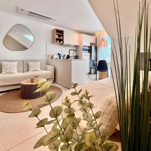 a living room with a bed and a couch and a table at Ti Paradis with Private rooftop in Grand-Baie