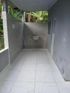 a bathroom with a sink and a tile floor at Kitnet na mata atlantica in Ubatuba