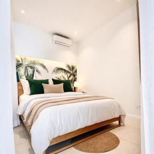 a bedroom with a large bed with green pillows at Ti Paradis with Private rooftop in Grand-Baie +19 photos