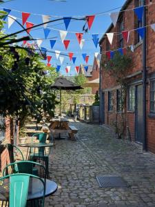 a patio with tables and flags on a street at The Black Swan Inn in Devizes +57 photos
