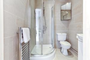 a bathroom with a shower and a toilet and a sink at Fabulous Apartment Central London in London