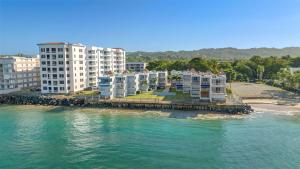 a group of buildings on the shore of the water at Beachfront apt with amazing views in Stella