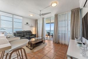 a living room with a couch and a table at Beachfront apt with amazing views in Stella