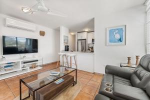 a living room with a couch and a table at Beachfront apt with amazing views in Stella