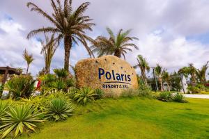 a sign for polarts resort and spa with palm trees at Polaris Resort & Spa in Xóm Tram