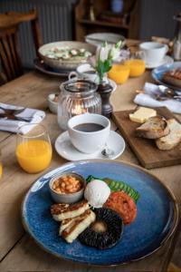 a table with a blue plate of food on it at The Black Swan Inn in Devizes