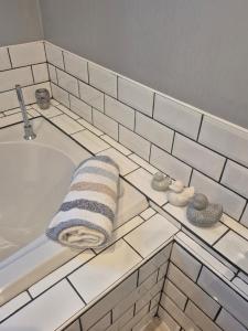a bathroom with a sink and a towel on a tub at Coast to Coast Accom - Shap in Shap +14 photos