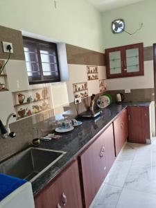 a kitchen with a sink and a counter top at Bay Breeze Vijay Villa in Pondicherry
