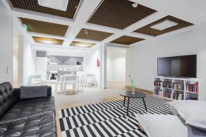 a living room with a couch and a tv at Hostel Café Koti in Rovaniemi