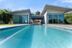 a swimming pool in front of a house at Casa Palma y Sol with private pool in Aguada