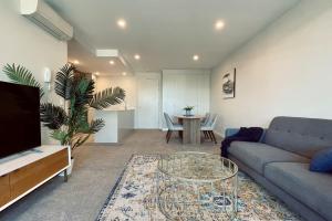 a living room with a couch and a table at Big, Bold, Barton in Barton