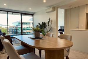 a dining room with a wooden table and chairs at Big, Bold, Barton in Barton +1 photo