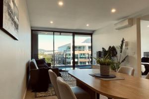 a living room with a table and a couch and a chair at Big, Bold, Barton in Barton