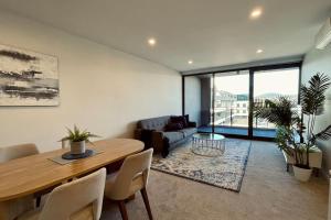 a living room with a table and a couch at Big, Bold, Barton in Barton