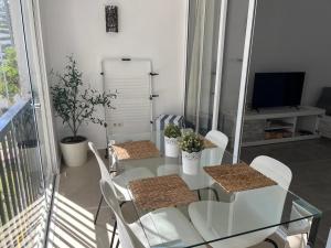 a dining room with a glass table and chairs at Volver in Mijas Costa