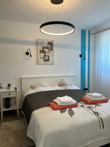 a bedroom with a bed with two towels on it at Ivezić in Njivice +53 photos