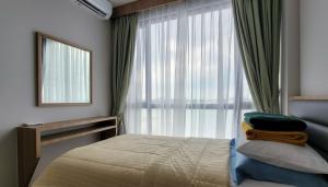 a bedroom with a bed and a large window at 3 Bed Room One Residence by momo in Pulau Sembakau Kecil