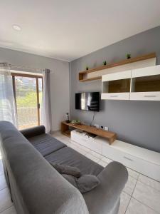 a living room with a couch and a television at St Julians Mansion Rooms in St. Julianʼs