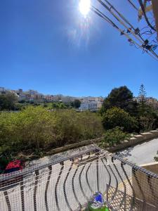 a view of a fence with the sun in the sky at St Julians Mansion Rooms in St. Julianʼs