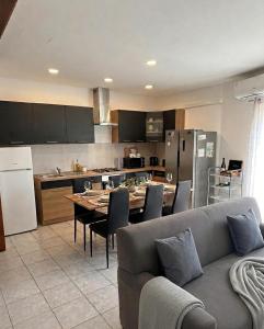 a kitchen with a couch and a table with chairs at St Julians Mansion Rooms in St. Julianʼs