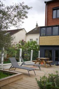 a patio with two chairs and a table on a deck at Olivia in Argenteuil
