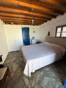 a bedroom with a large bed and a wooden ceiling at Villas Kalafatis Apartments in Kalafatis