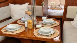 a table with plates and dishes on it in a bedroom at Velero Nadya in Arrecife