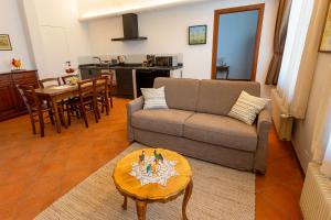 a living room with a couch and a table at Ca'Bastian-Guest House in Moruzzo