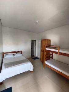 a bedroom with two beds in a room at Criptos Hotel e Restaurante in Várzea Grande
