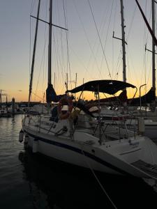 a sailboat docked in a marina with the sunset in the background at Velero Nadya in Arrecife