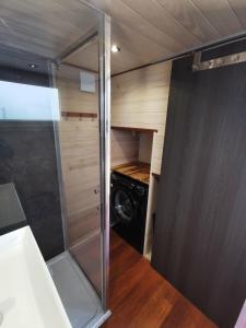 a small bathroom with a washer and dryer at La Tiny des Prés in LʼAbsie +11 photos