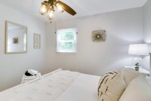 a white bedroom with a bed and a ceiling fan at Memes Cottage Near Nelson 151 in Afton