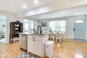 a kitchen and dining room with a sink and a table at Memes Cottage Near Nelson 151 in Afton
