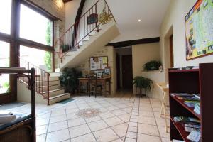 a room with a staircase and a table with chairs at La Chaume en Loire in Devay