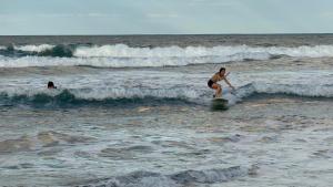 a person riding a wave on a surfboard in the ocean at The Stoked Hideout - Bagasbas Beach in Daet