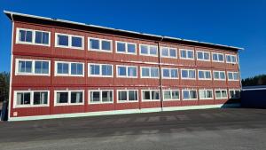 a large red building with many windows on the side at North Home in Skellefteå