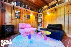 a living room with a couch and a glass table at The Shack at Long Beach - A Psychedelic Getaway in Long Beach