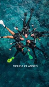 a group of people swimming in the water at Porto Roma Seaside Studios in Vasilikos