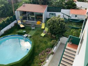 an overhead view of a backyard with a swimming pool and a house at Casa Ti Carolina in Nazaré